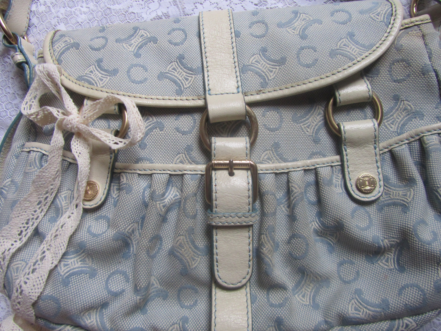 Light blue patterned bag with beige accents on a textured surface