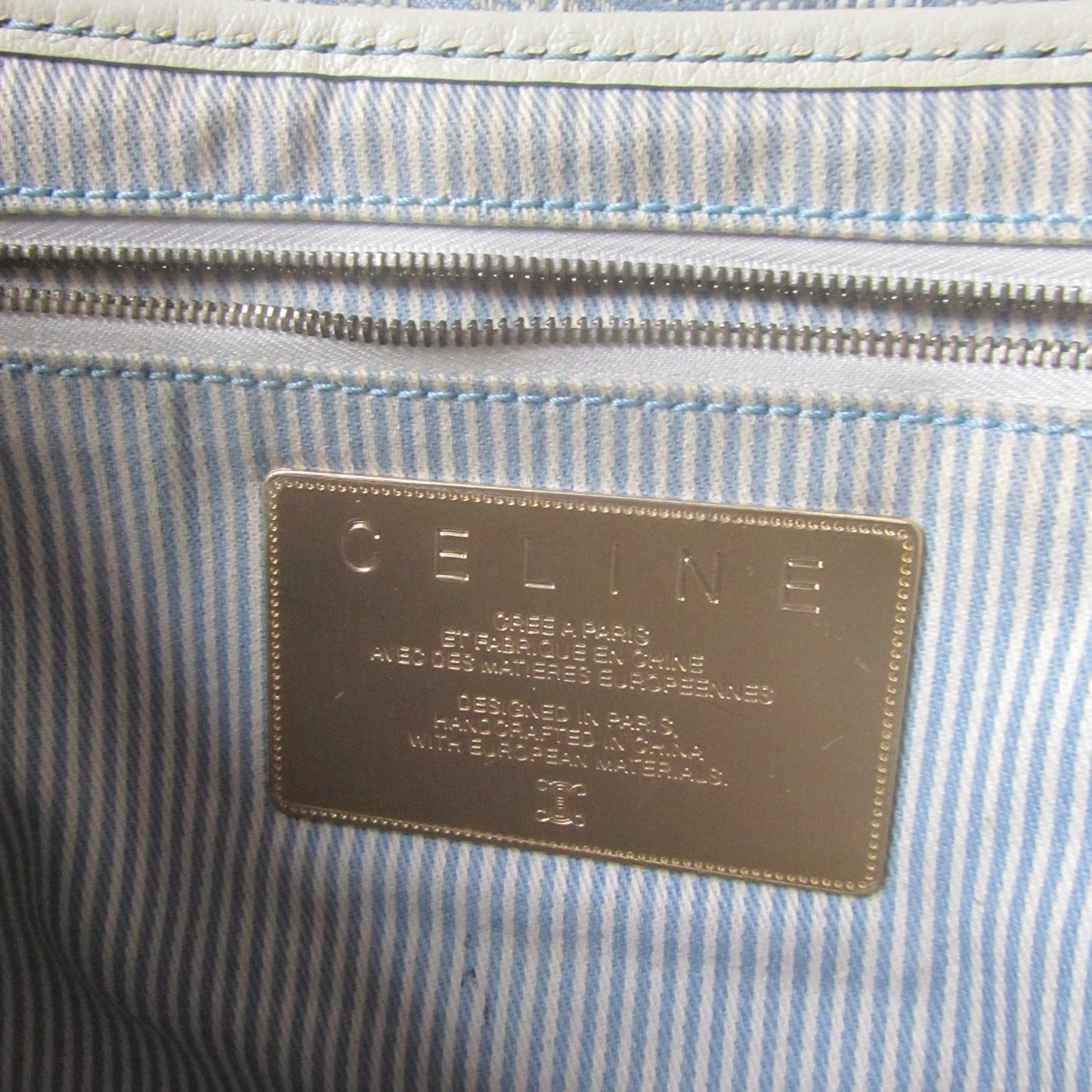 Close-up of a striped fabric with a brand label on a blue and white background