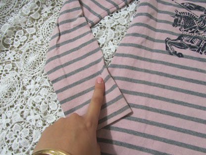 sleeve of a pink striped dress on a lace background