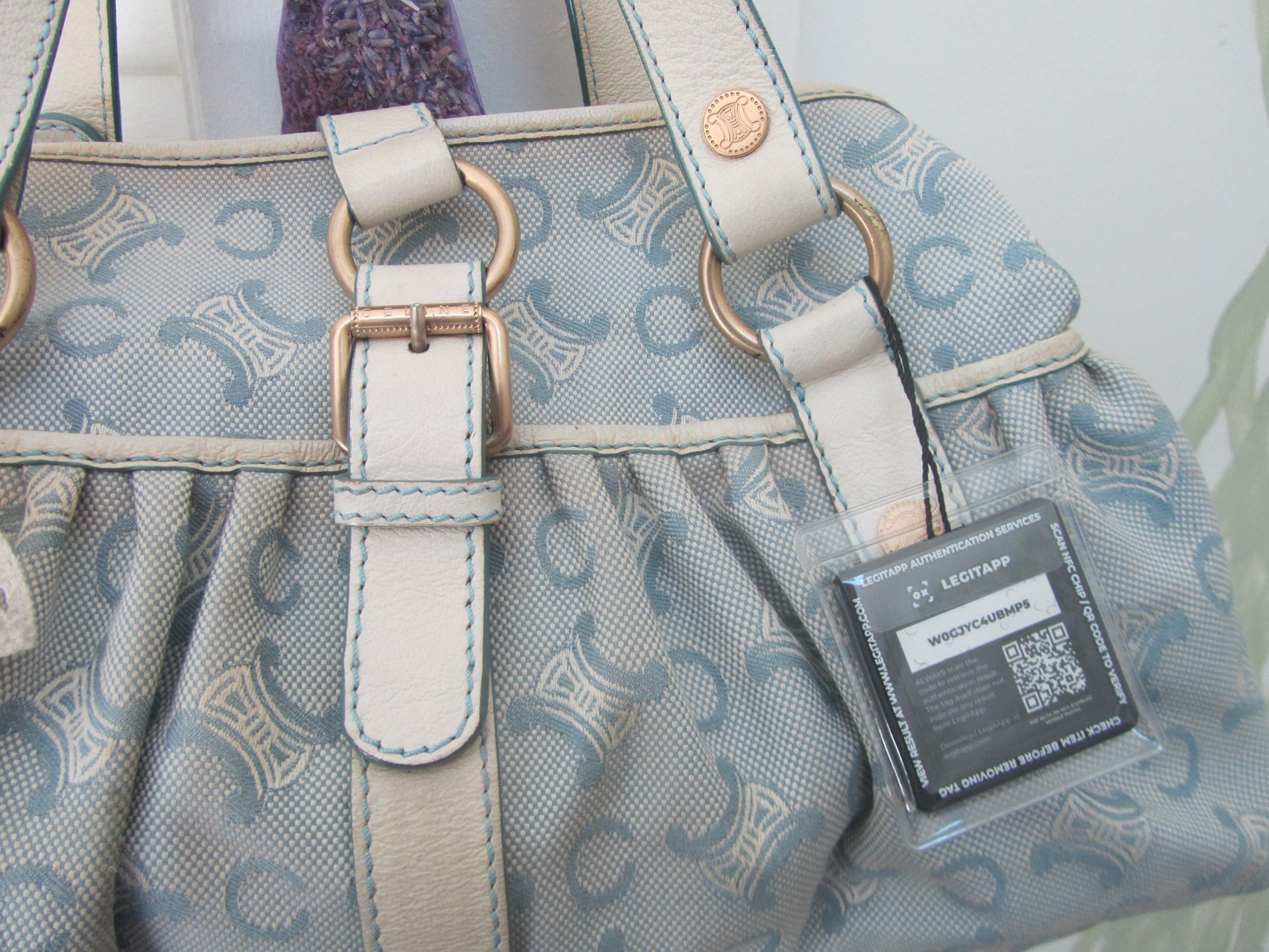 Patterned handbag with a visible brand label on a light background