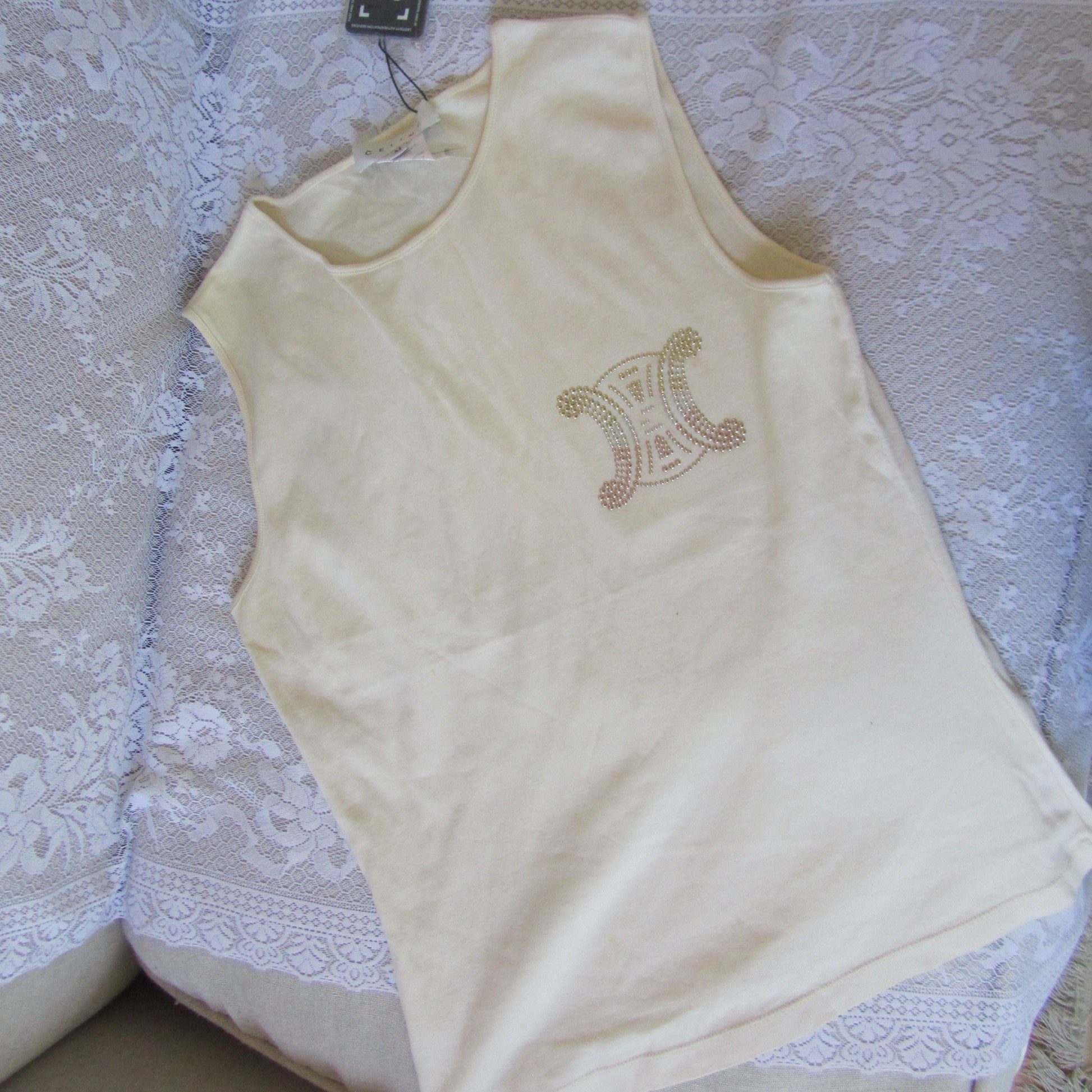 Beige garment with a decorative emblem on a textured surface