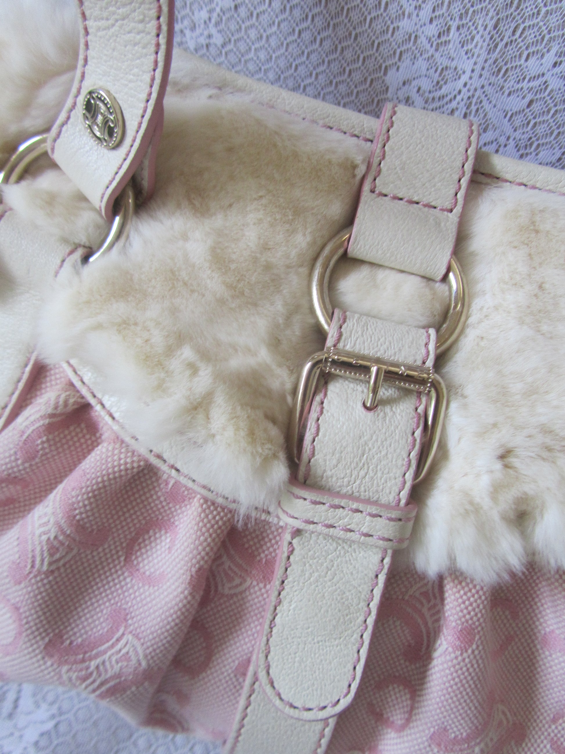 Close-up of a pink bag with fluffy interior on a textured background