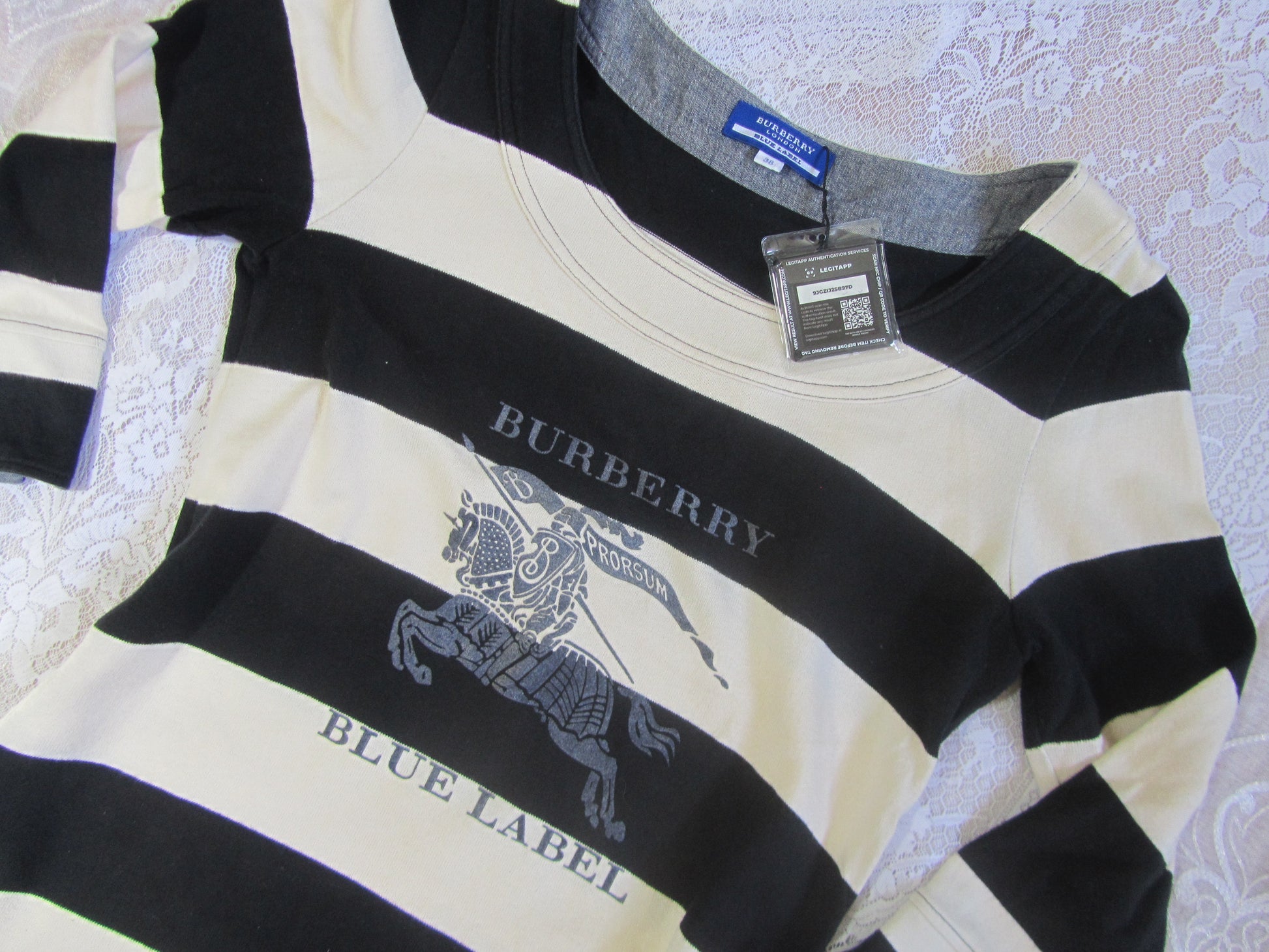 Black and white striped shirt with Burberry logo on a textured surface