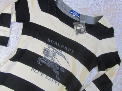 Black and white striped shirt with Burberry logo on a textured surface