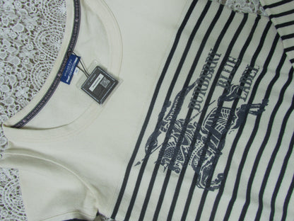 White garment with black lace details and a visible brand tag on a white background