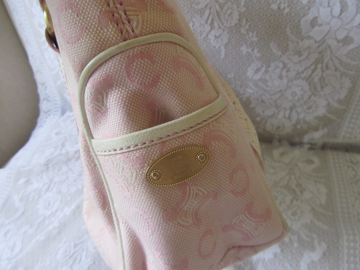 Pink patterned bag on a textured white surface