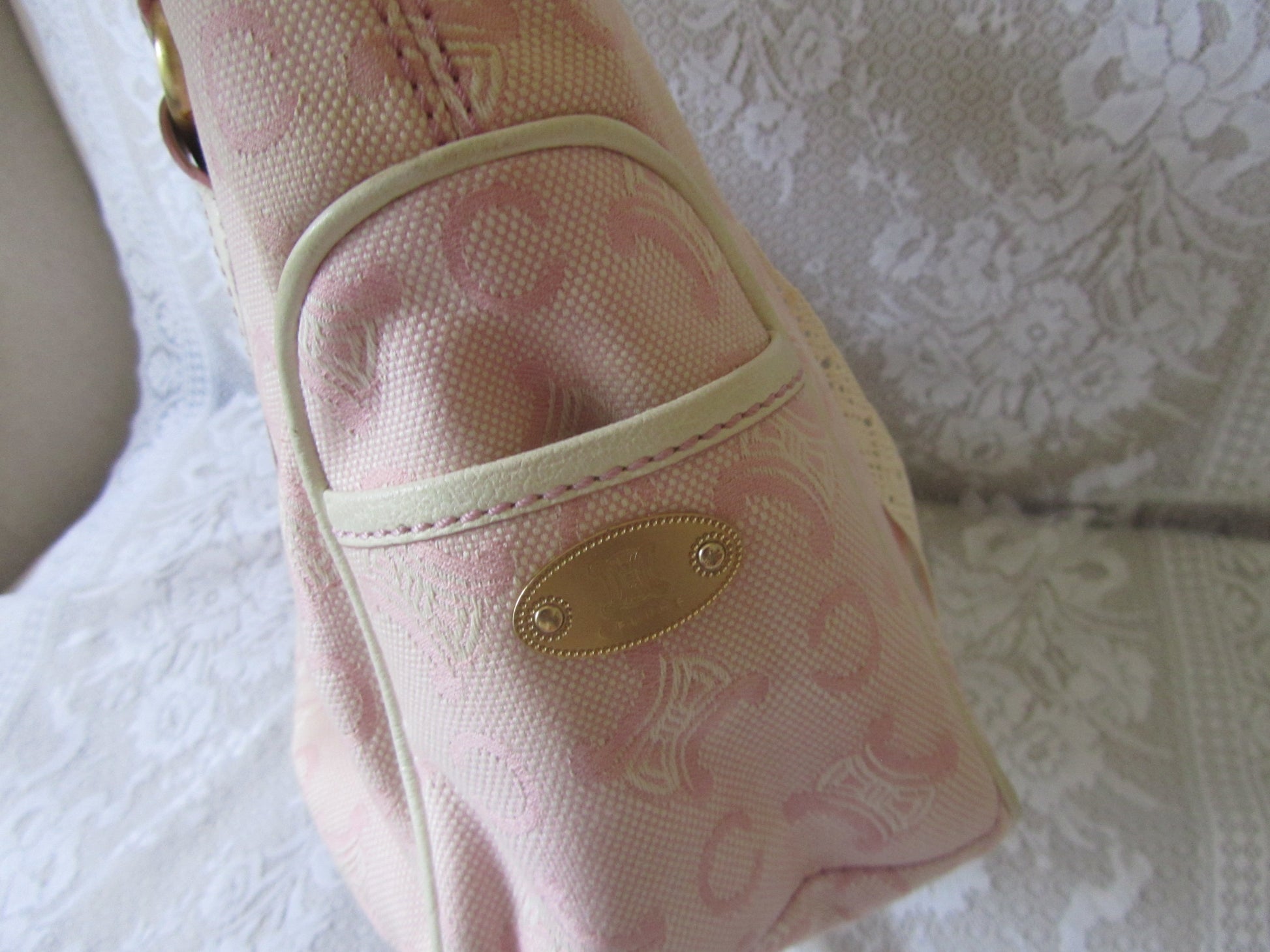 Pink patterned bag on a textured white surface