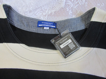 Close-up of a Burberry shirt collar with a tag on a textured background