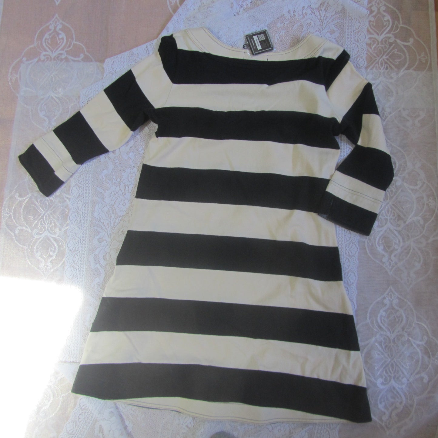 Black and white striped dress on a lace tablecloth