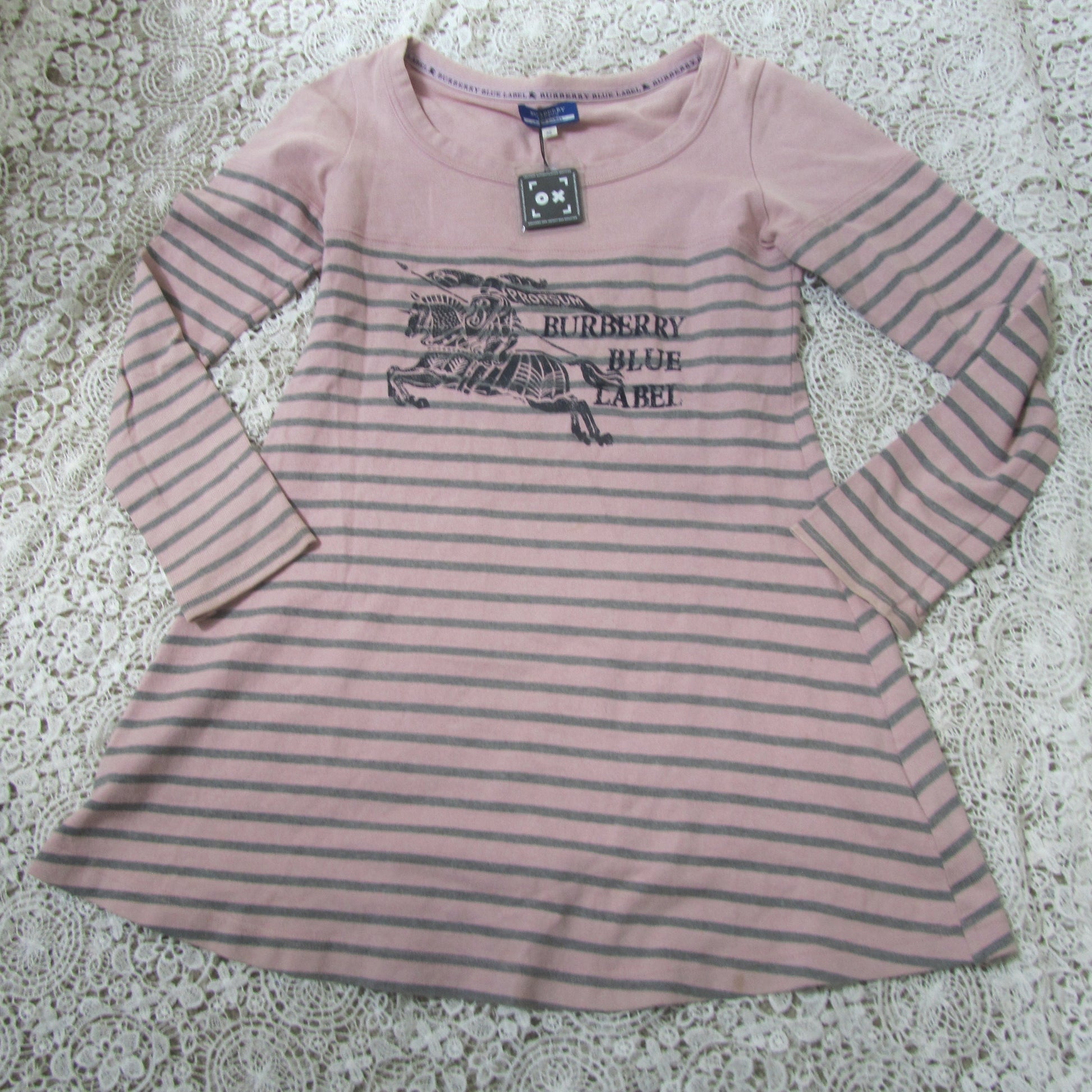 pink striped burberry blue label dress on a lace background