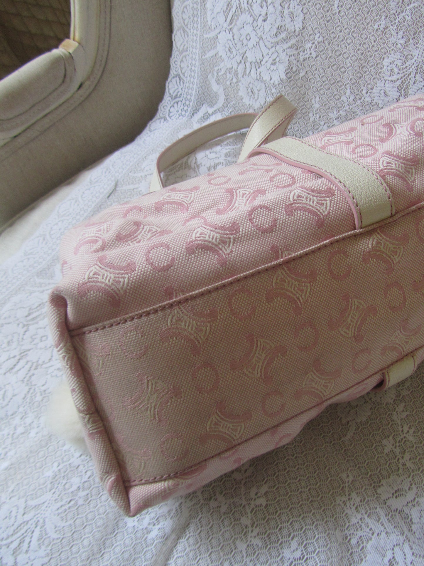 Pink patterned bag on a textured white surface