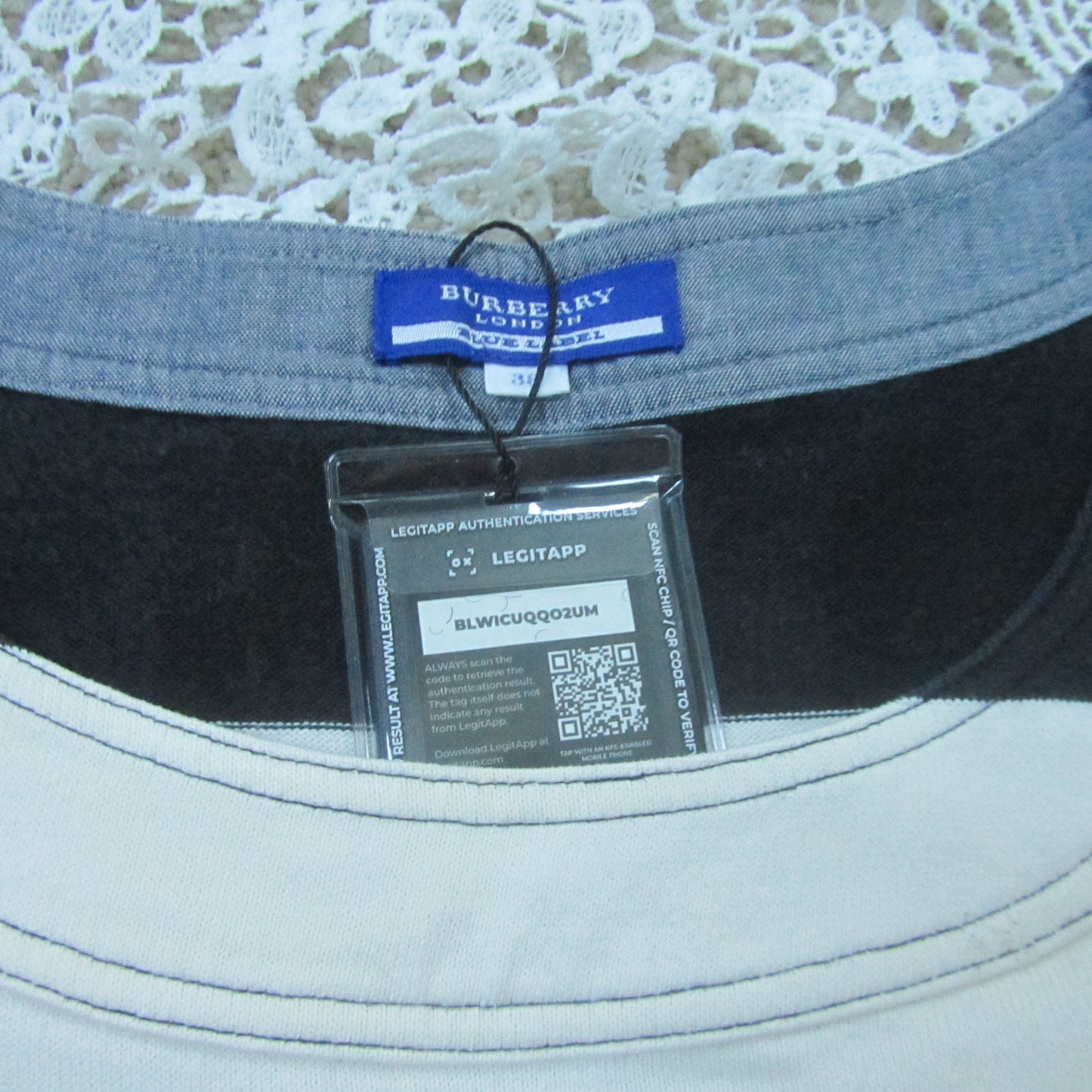 Gray t-shirt with Burberry tag and QR code label on a lace background