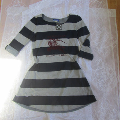 Striped dress with a brand label on a patterned surface