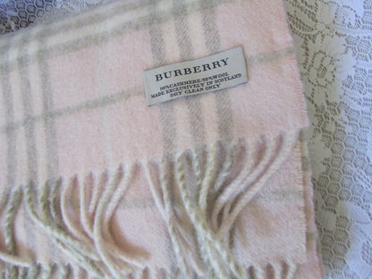 Plaid scarf with a brand label on a textured white surface