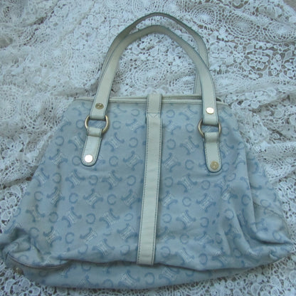 Light blue handbag with a pattern on a textured surface