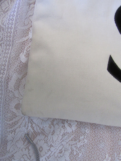Beige tote bag   on a textured white background