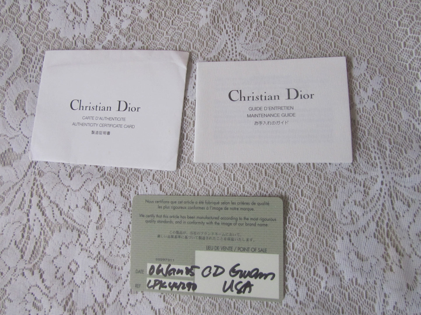 Two 'Christian Dior' cards on a textured surface