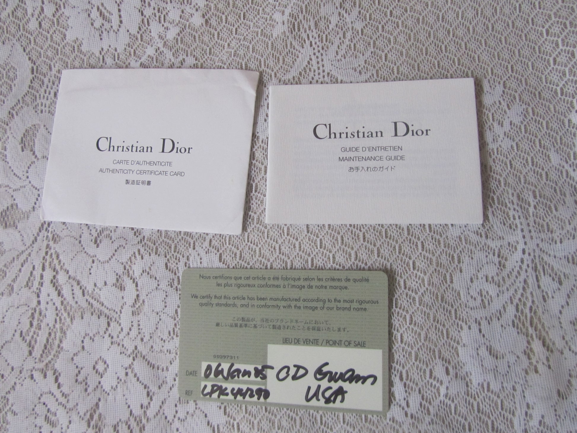 Two 'Christian Dior' cards on a textured surface