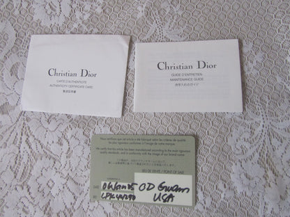 Two 'Christian Dior' cards on a textured surface