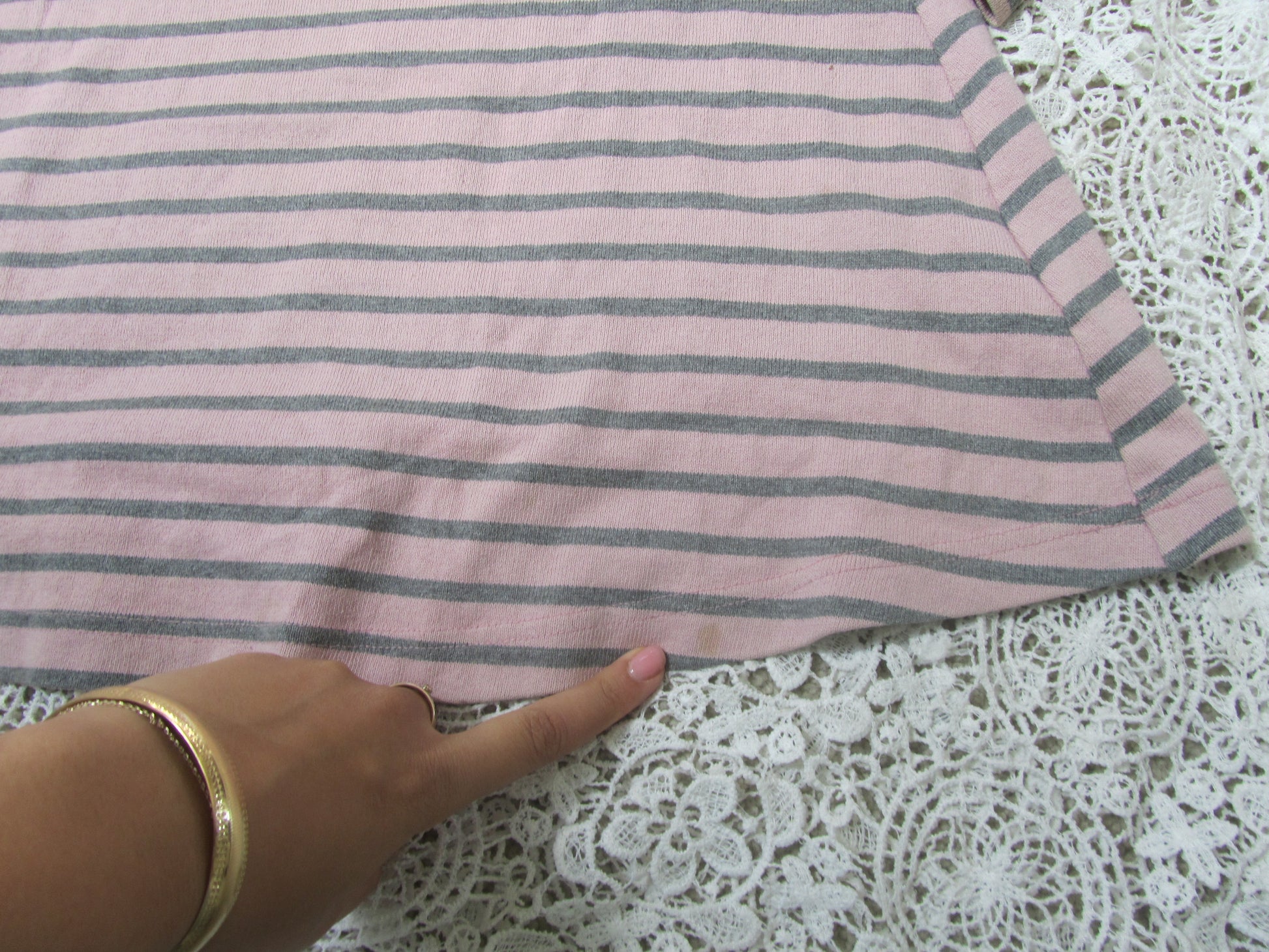 bottom of a pink striped dress on a lace background
