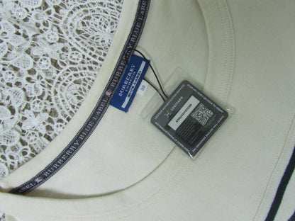 Close-up of a white lace garment with a Burberry label and tag.