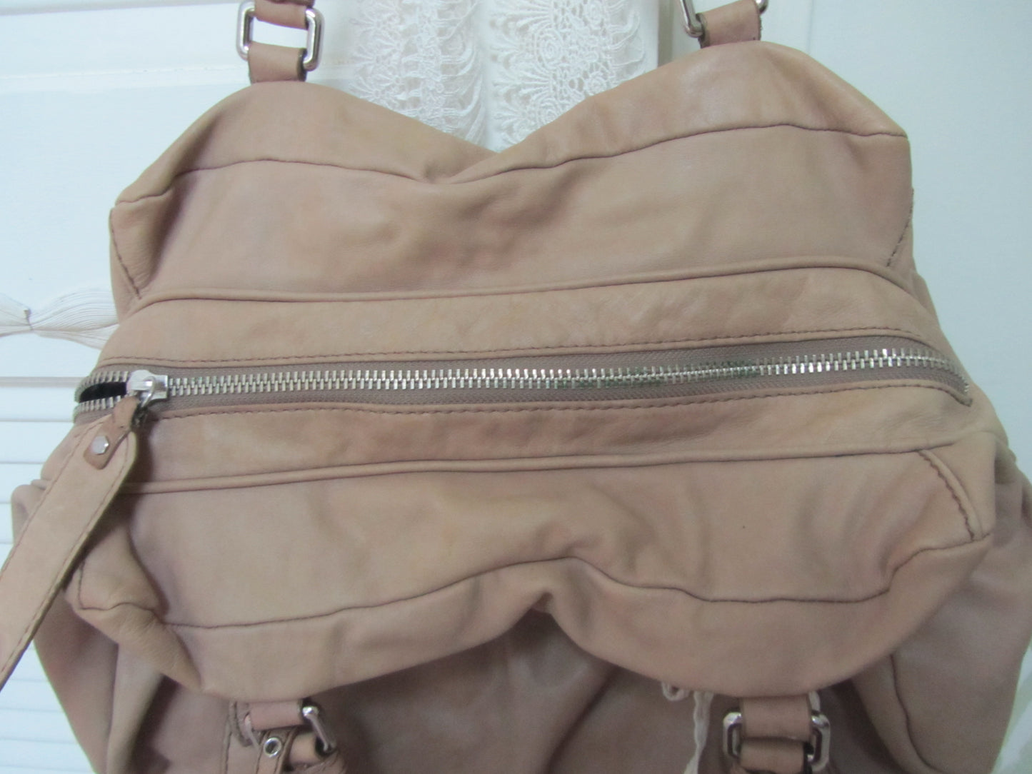 Beige backpack with zippers on a white background