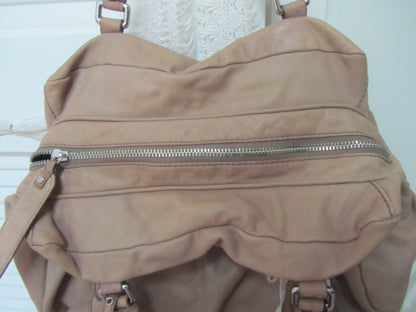 Beige backpack with zippers on a white background