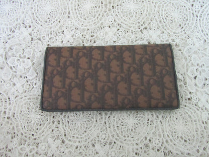 Brown wallet with a pattern on a textured white surface