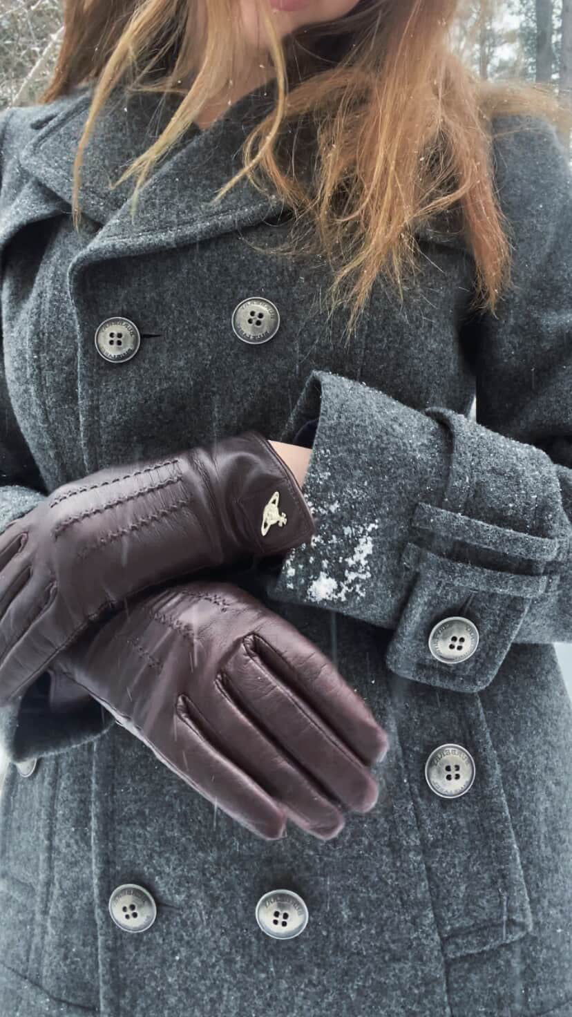 Woman wearing grey Burberry double-breasted wool coat with leather gloves