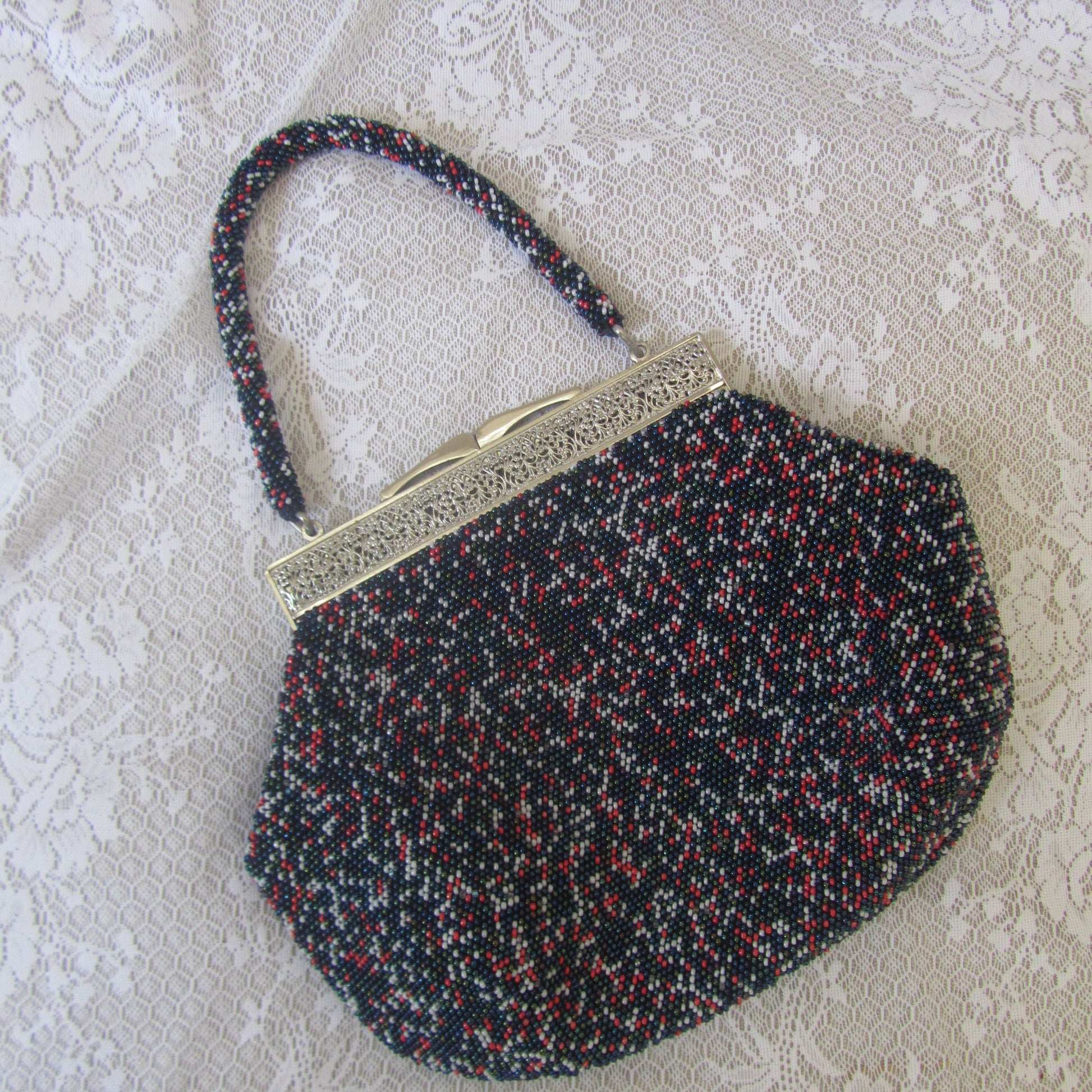 Textured bag with a gold clasp on a textured surface