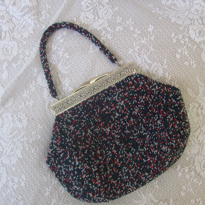 Textured bag with a gold clasp on a textured surface