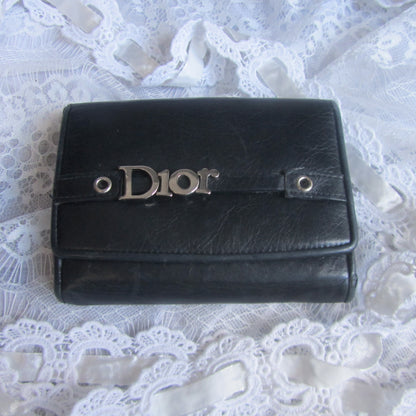 Black Dior wallet on a white lace background
