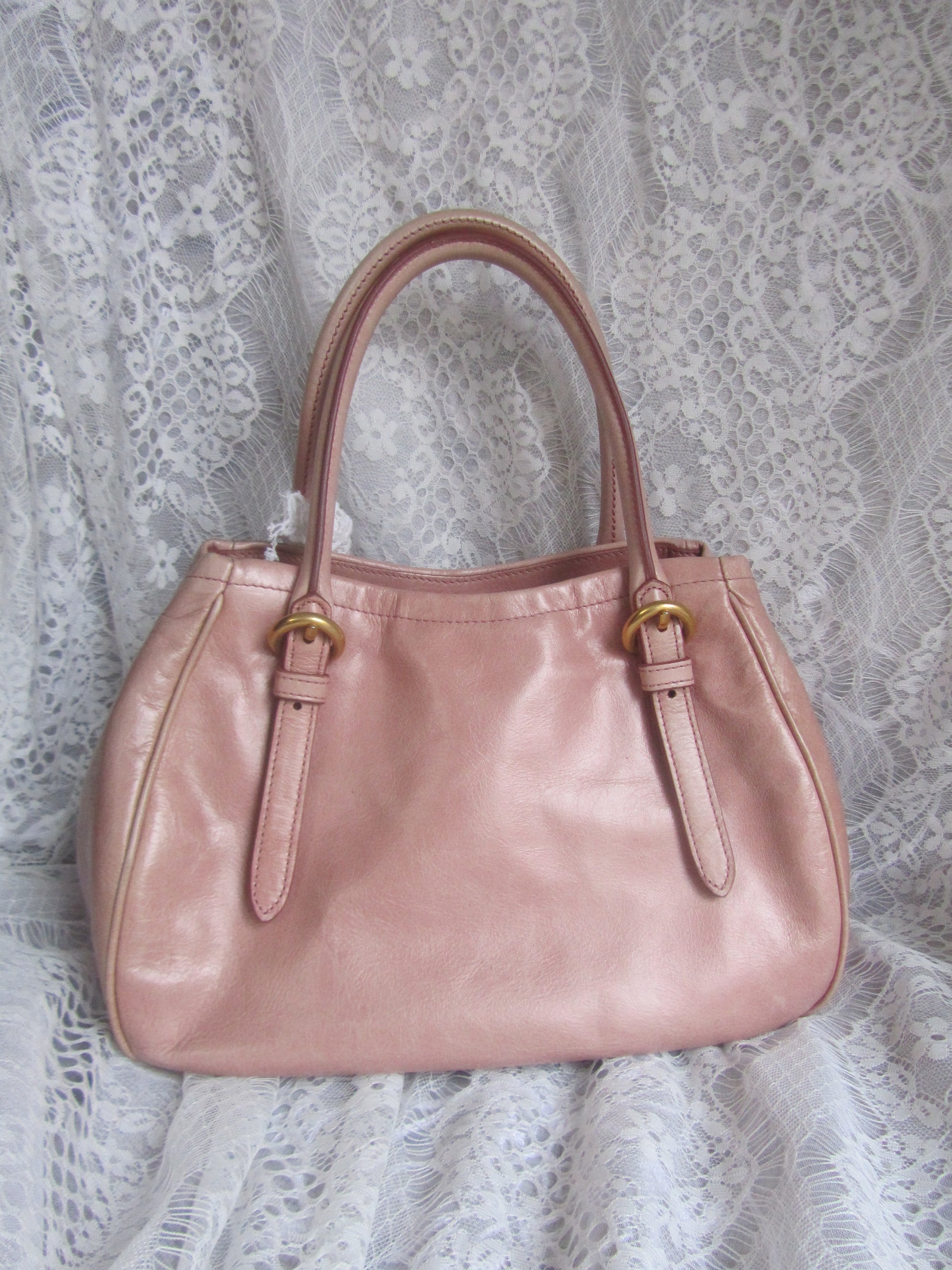 Pink handbag on a lace fabric background