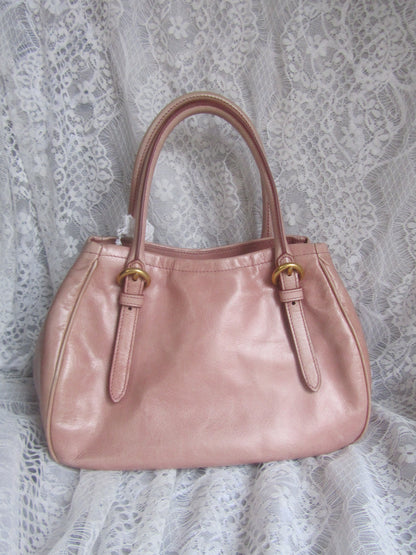 Pink handbag on a lace fabric background