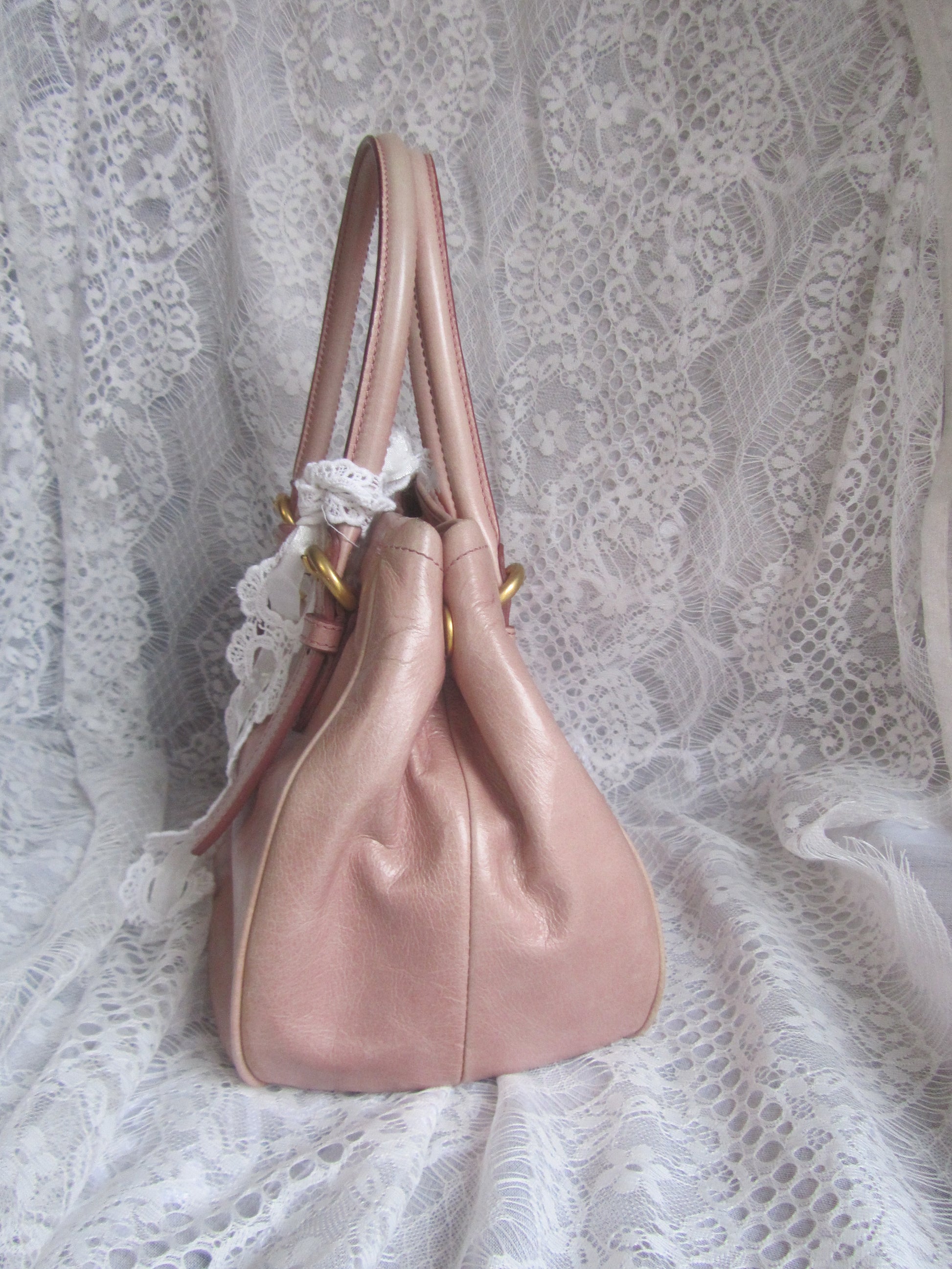 Pink handbag on a lace fabric background