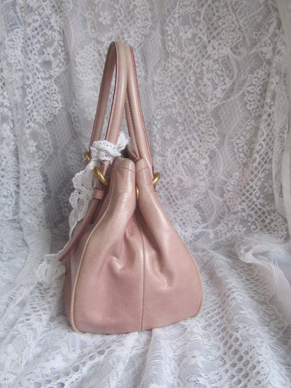 Pink handbag on a lace fabric background