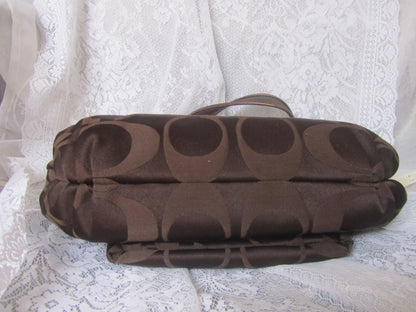 Brown textured bag on a white lace fabric background
