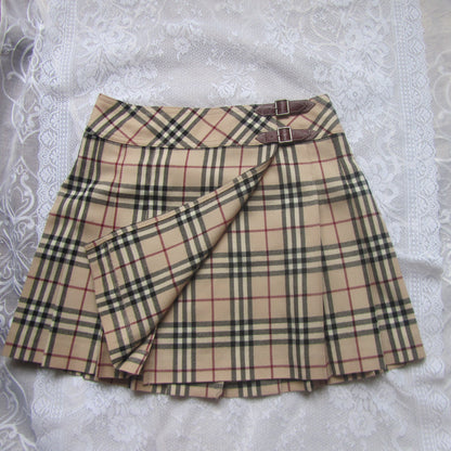Plaid skirt with a belt on a textured white surface