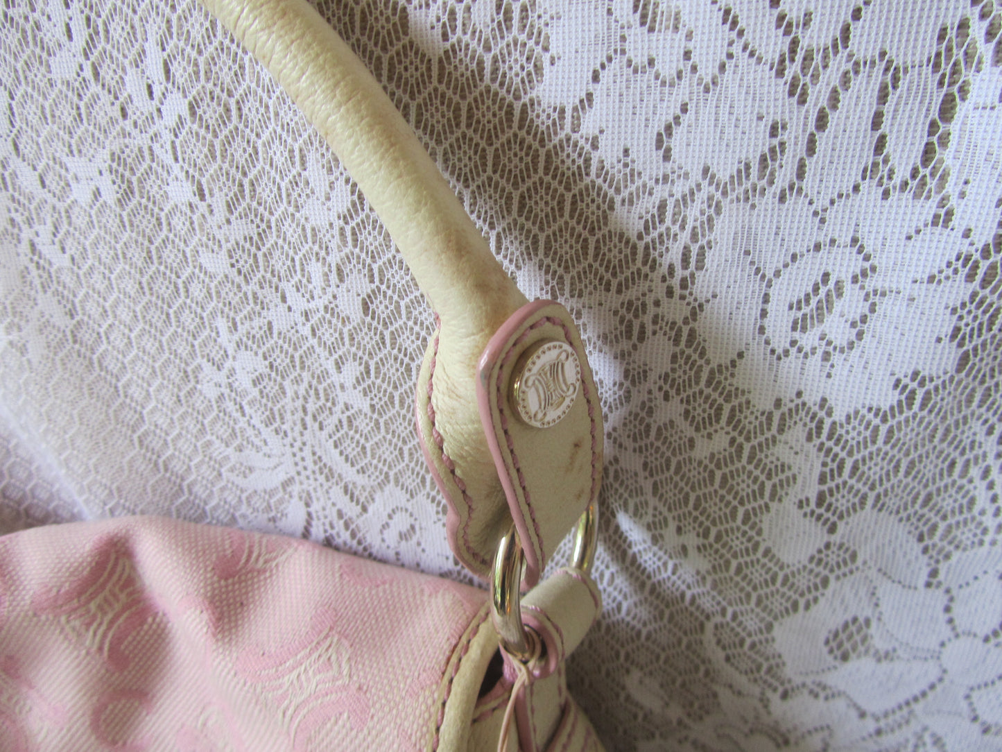 Beige strap with pink buckle on a pink fabric background