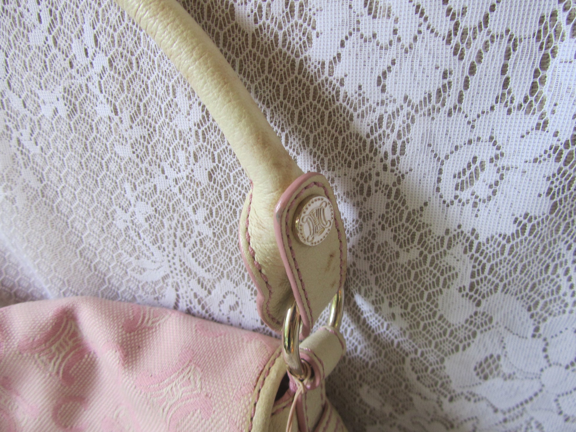Beige strap with pink buckle on a pink fabric background