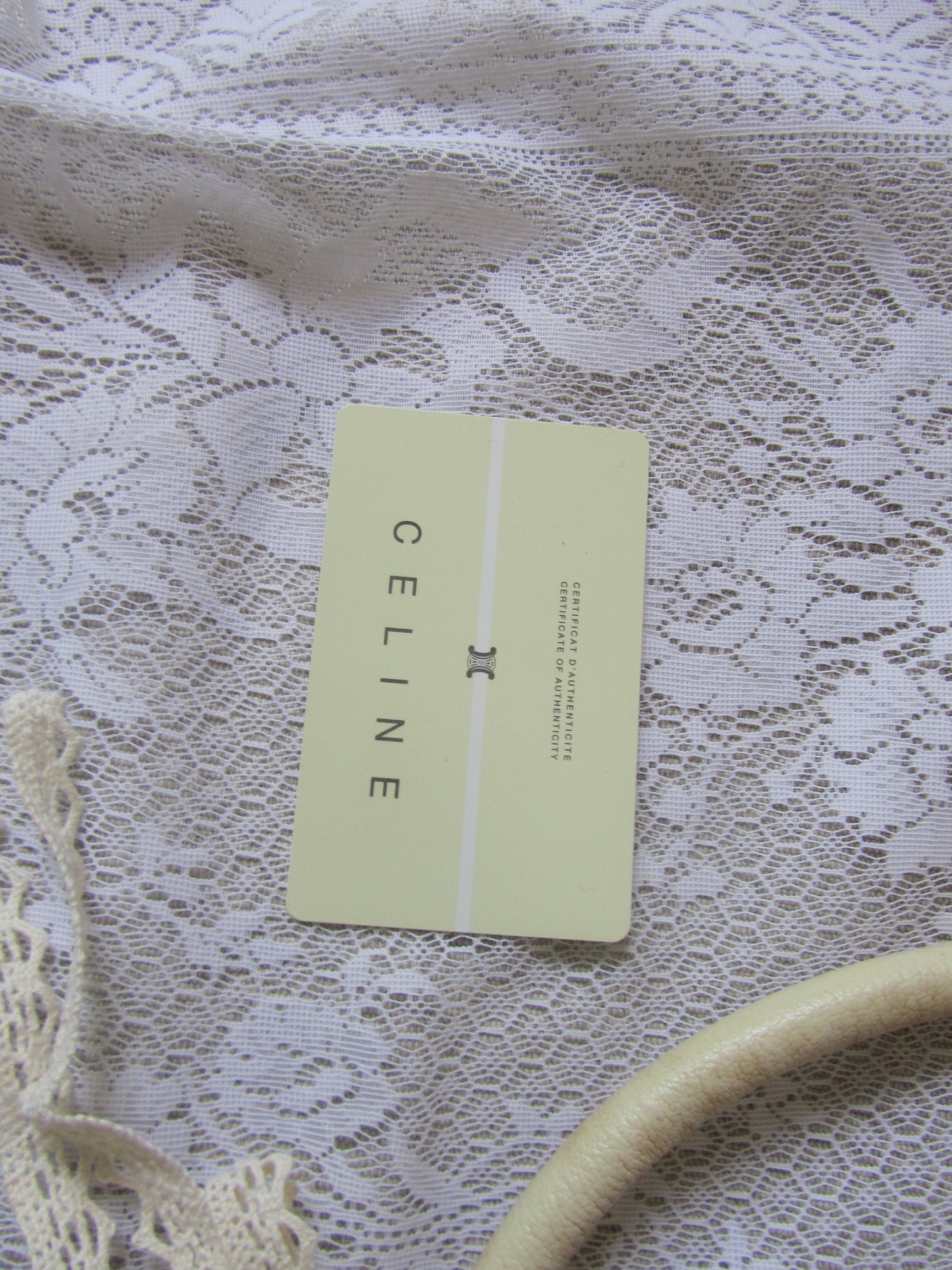 Celine card on a lace fabric background