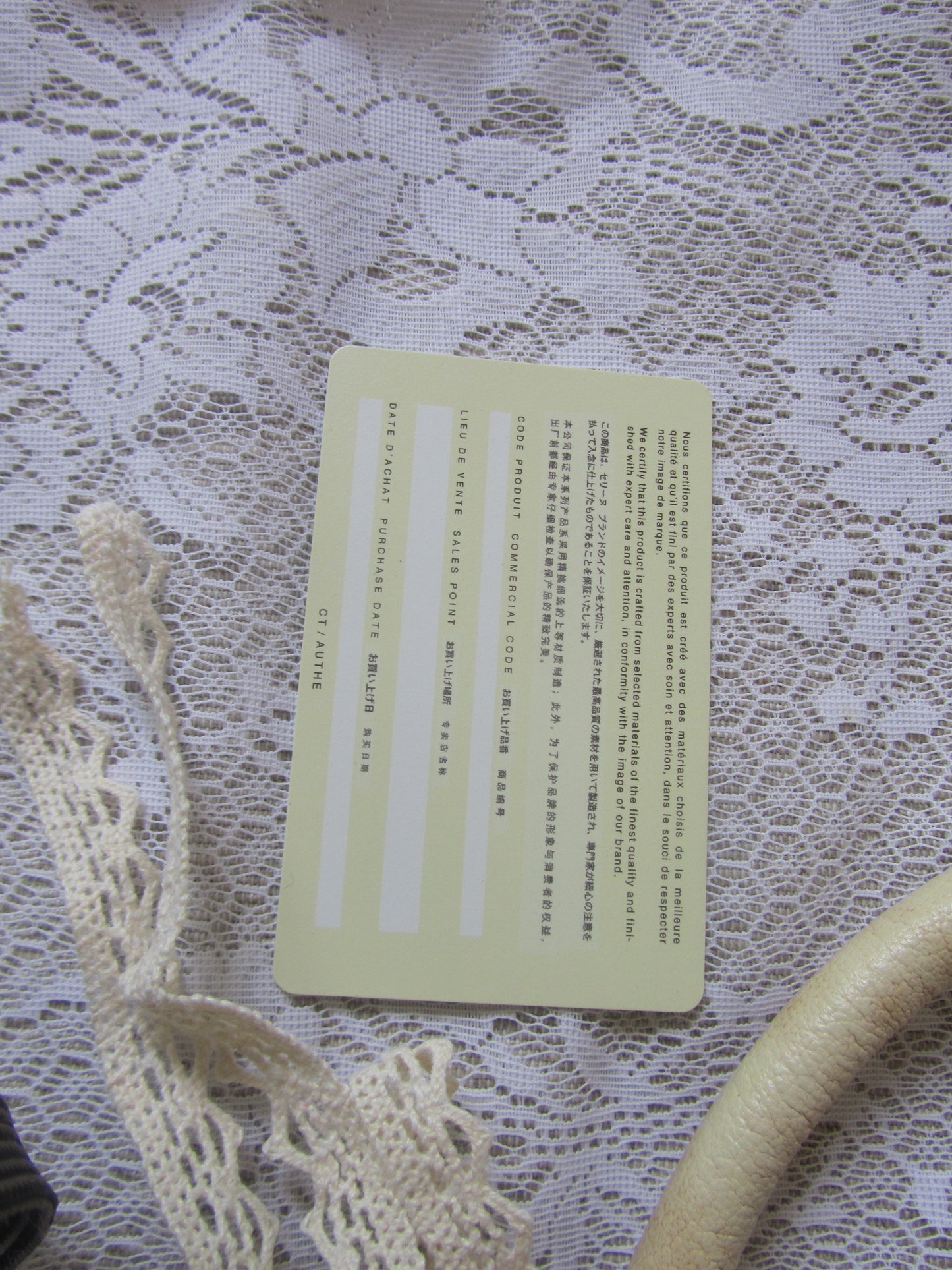 Yellow card with text on a lace fabric background