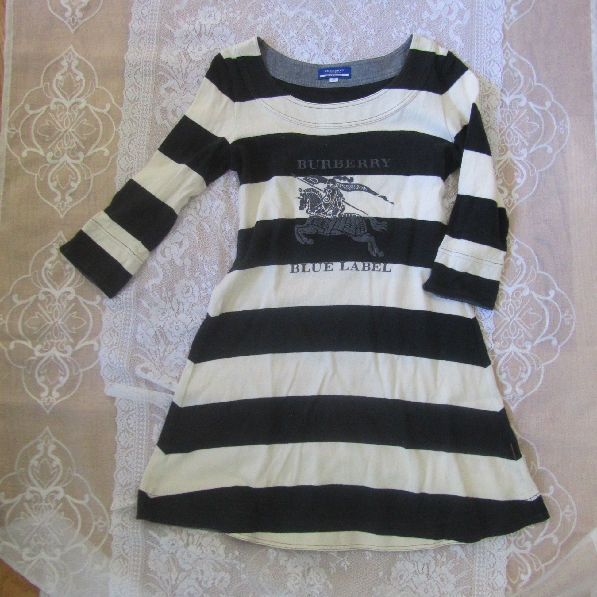 Black and white striped shirt on a lace tablecloth