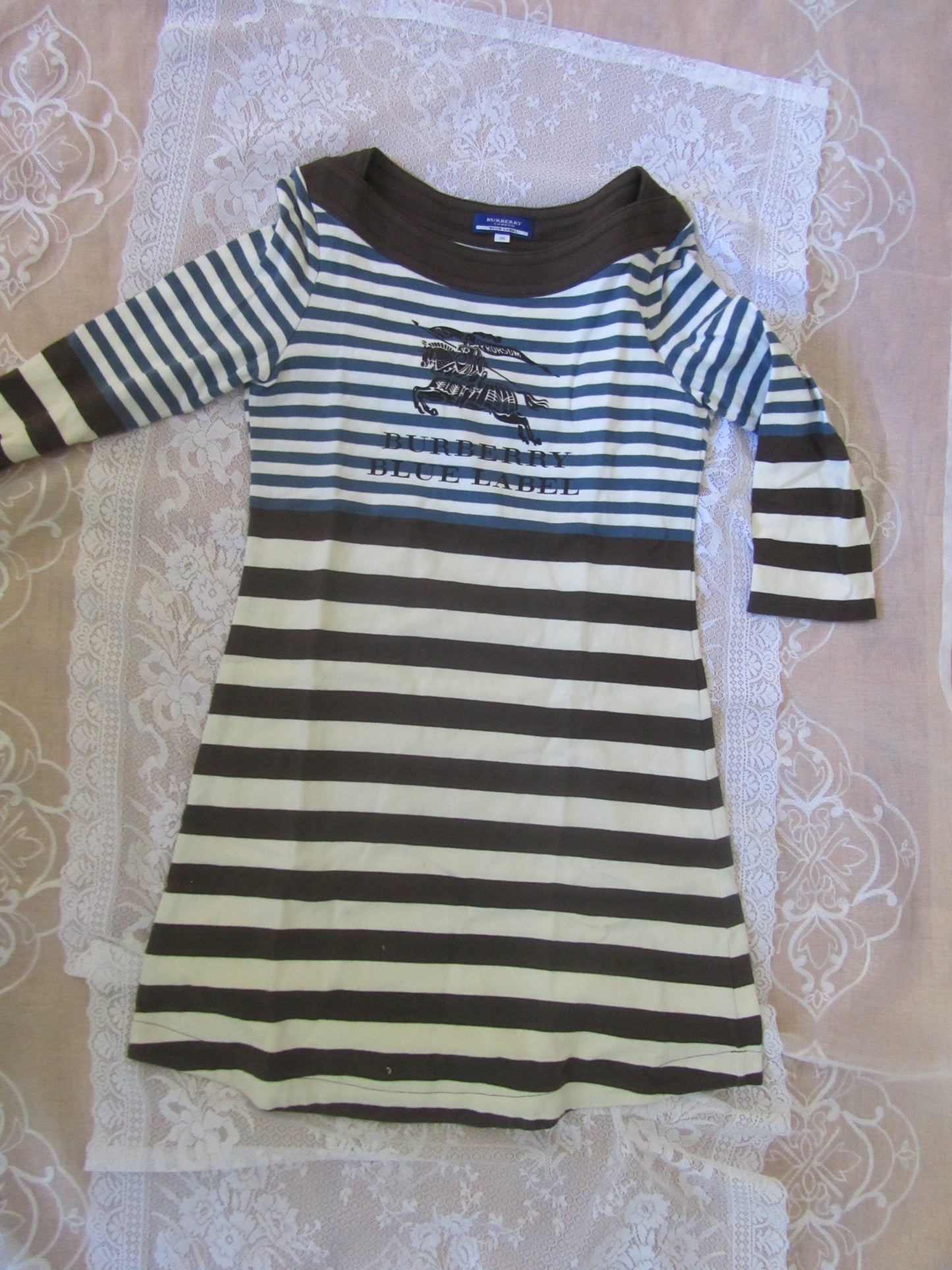 Black and white striped shirt on a lace tablecloth