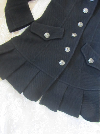 Close-up of a dark blue coat with buttons on a light background