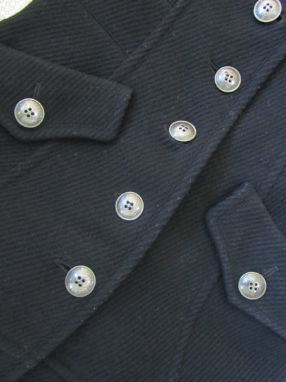Close-up of a dark blue textured fabric with buttons