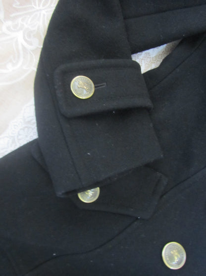 Close-up of a dark coat with buttons on a textured surface