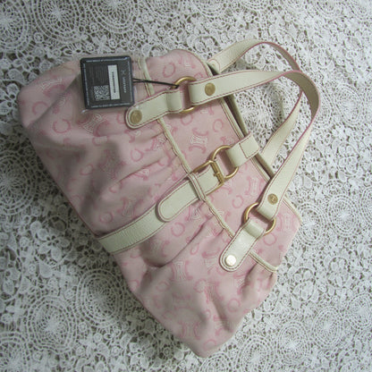 pink celine bag with cream handles and gold details on a lace background with a legitapp tag