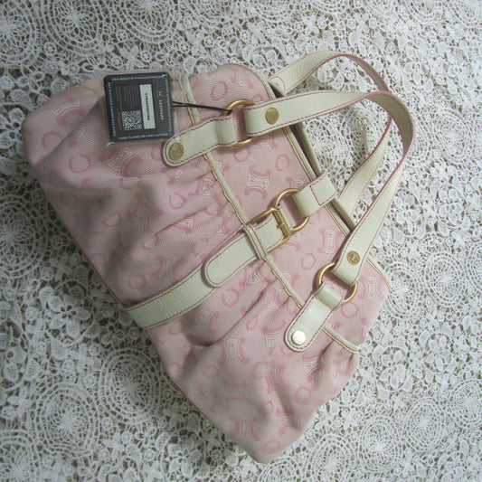 pink celine bag with cream handles and gold details on a lace background with a legitapp tag