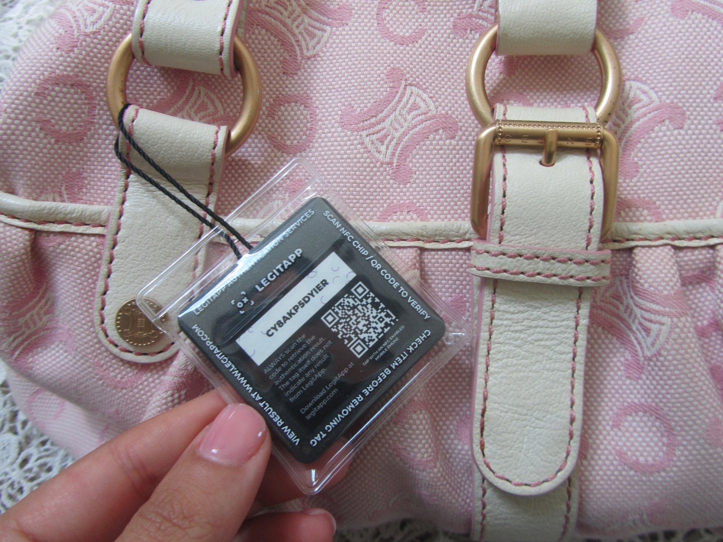 pink celine bag with cream handles and gold details on a lace background with a legitapp tag